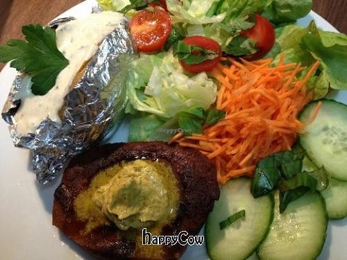 seitansteak with homemade vegan herbed butter, backed potato and cream, mixed salad at Cafebar Salon in Basel