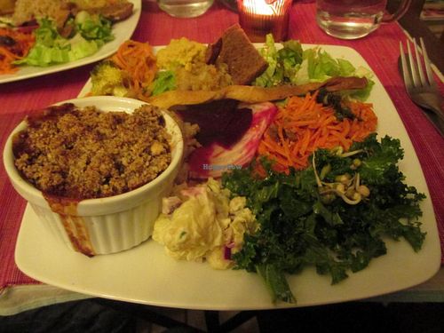 Dinner meal - savory vegetable crumble with salads. at Cafe Ginger in Paris