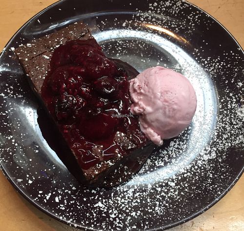chocolate cake with raspberry ice cream at Saramago Cafe Bar in Glasgow