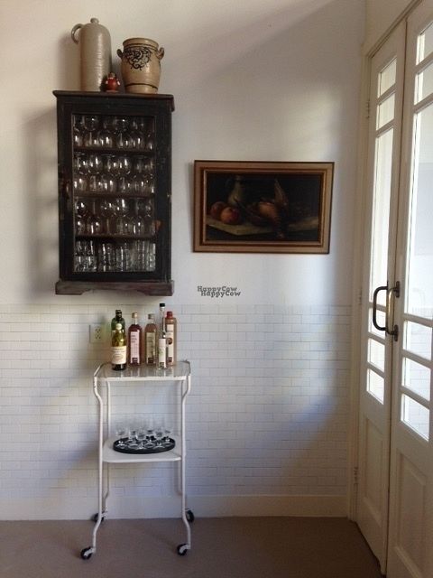 vintage interior with beautiful glas cabinet and liquor trolley full of Dutch (locally brewed) gin, jenever, liqueur at Marits Eetkamer in Amsterdam