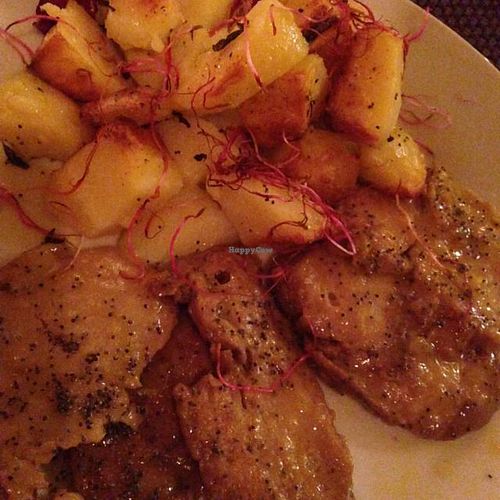 Seitan scaloppini with orange sauce rather than lemon. Side of roasted potatoes.  at Origami in La Spezia
