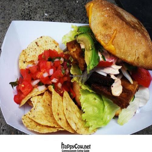 Baked Tofu Sandwich with spicy Veganaise aioli, lettuce, tomatoes, red onions, and avocado on ciabatta. at Dandelion Food Cart in Madison