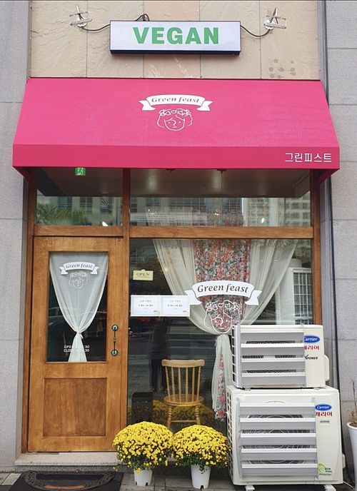 The front of the restaurant proudly displays its VEGAN sign  at Green Feast in Sejong