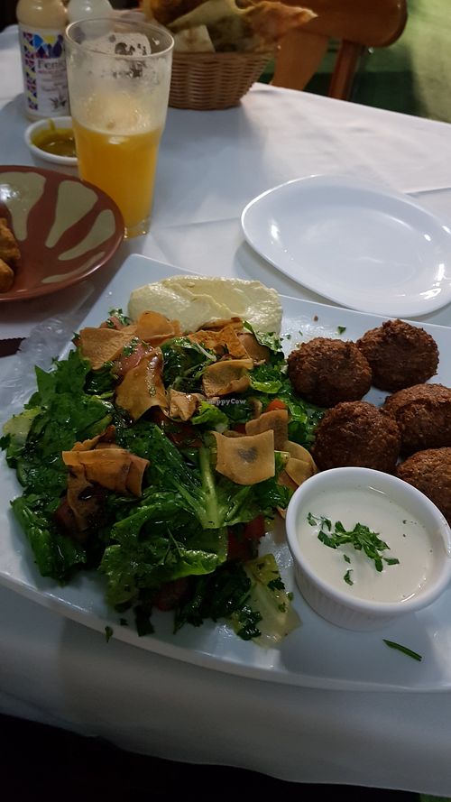 Falafel with fatouch salad, very well served with hummus and a basket with bread. R$40.  Falafel are well seasoned and were not fried in the same oil as meat, so it's very tasty. at Basha in Rio De Janeiro