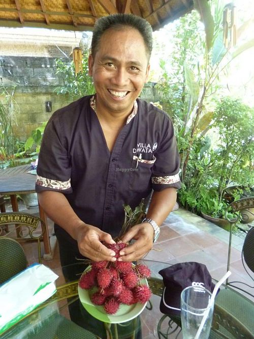 The friendly owner with fresh rambutan at Tasty Vegan in Seminyak