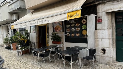 Tables outside and insidee  at Kasthamandap Restaurant And Cafe House in Lisbon