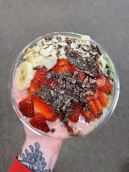 This is a Pacific Green Bowl with half Stupid Cupid base, almond butter, and cacao nibs! I also added vegan vanilla protein to my base! 🖤🍓  at Playa Bowls in Manchester