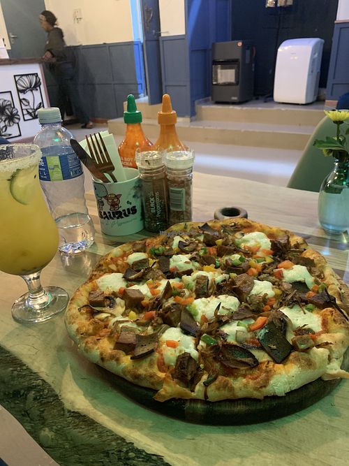 Meat lovers pizza and passion fruit margarita   at Pizzasaurus in Cape Town