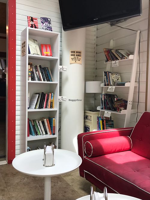 seating and books for sale in the back at Caffe Romeo in Charleston