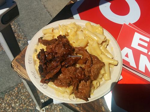 Bowl of BarBQ beef, mac & cheese, greens on the bottom at Southern Fried Vegan BBQ in Los Angeles