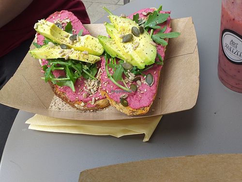 Beetroot hummus on sourdough toast with avocado, rocket and seeds at Squeezee in Barmouth