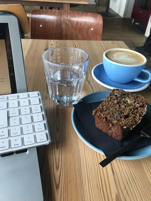 Oatmilk Cappuccino and vegan bananabread  at Barmhartig in Amsterdam