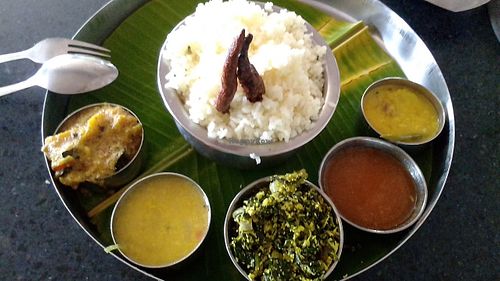The waiter is always ready to explain what's in each dish. at The Lemon Tree in Jaffna