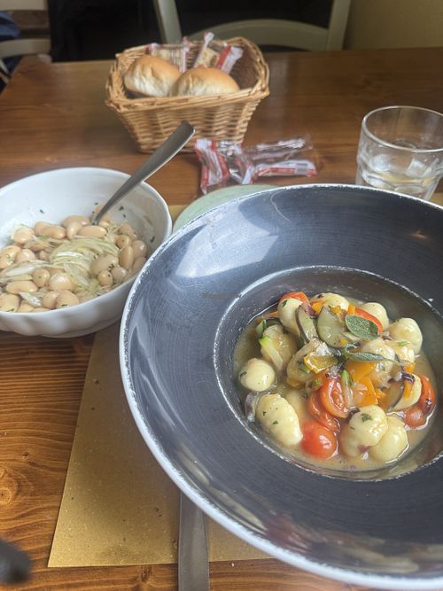 Vegan gnocchi and beans and onions as a side dish   at Osteria Al Fureghin in Burano