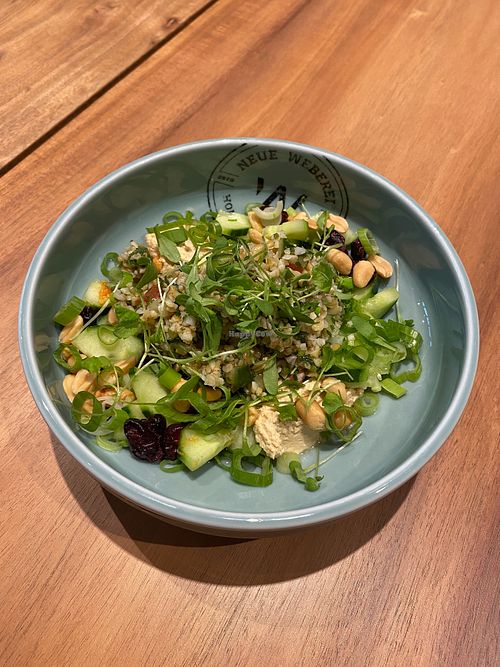 Our Tel Aviv Bowl with bulgur, hummus, spring onions, cranberries, nuts, cress and cucumber. at Neue Weberei in Wernau