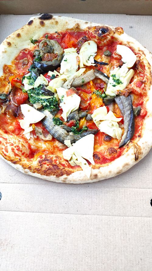 Pizza Barletta with tomato, caramelized onions, peppers, aubergine, capers, artichokes and parsley at Le Moulin Des Saveurs in Argentan