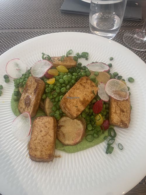 Grilled tofu with creamy pea purée, spring onion green pea ragout, and potatoes baked in jacket...  at KÜVÉ Bisztró és Borbár in Eger