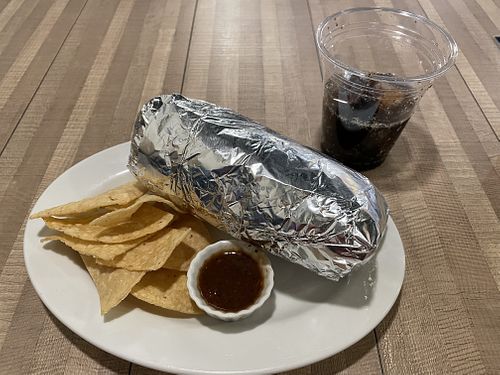 Large vegan burrito with chips and a drink! 1,600 yen. Filling but very bland… no spices. ^ - ^  at OC Burrito in Kyoto