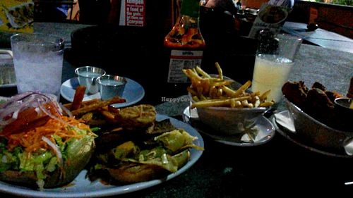 Oklahoma bacon cheeseburger, fries, and wings at Native Foods in Costa Mesa