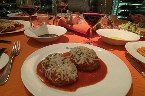 
GardeinTM Parmigiana and other vegan dishes on dinner table   at Wynn Hotel - Sinatra in Las Vegas