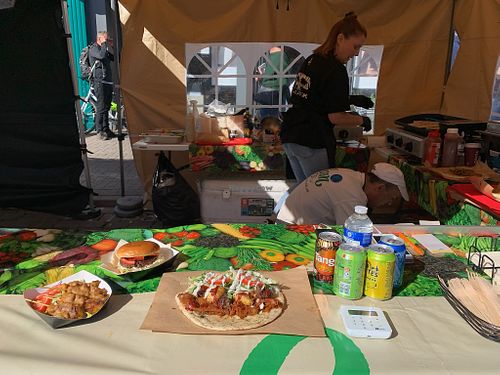 Market stall with displays of food options   at Vegan World in North London