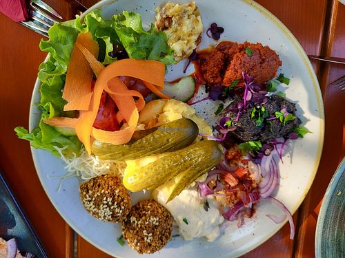 Big mixed vegan bread with different self-made spreads coming with German farmers bread, self-made Falafel and German potato salad at Vereinshain in Bamberg
