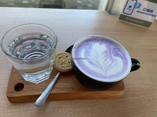 Taro latte with oatmilk (I’d guess the cookie isn’t vegan, I didn’t eat it)  at WARMA - Vegie Bakery & Coffee Shop in Ubud