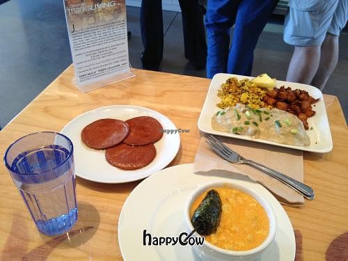 Canadian bacon, bowl of grits, biscuits, sausage gravy, scramble and potatoes.  at Green New American Vegetarian in Phoenix