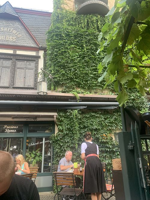 Typical German waitress and waiters  at Weingasthaus Breuer's Rüdesheimer Schloss in Ruedesheim Am Rhein