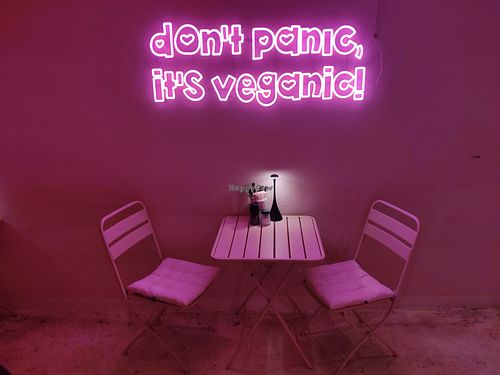 Table with neon light at RAZZO Vegan Pizza Bar in Cologne