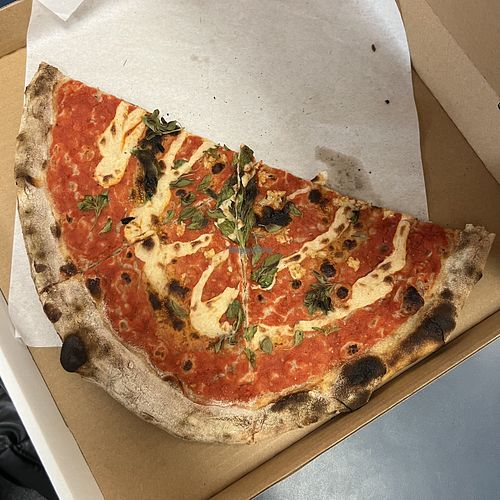 vegan pizza (half eaten)  at Pizza Casette in San Diego