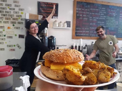 Vegan sausage, egg, and cheese everything bagel with homefries, and the workers being Vanna White and Pat Sajak. at Kickstart Cafe in Shelton