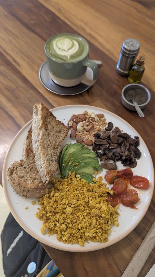 Tofu revuelto con pan, palta, frutos secos, hongos, y tomates + un matcha latte con leche vegetal at Chicama in Buenos Aires