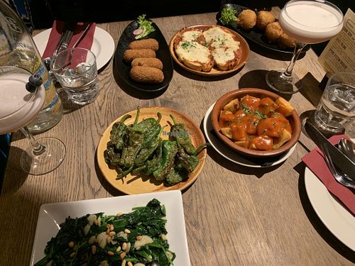 NOTE: back three dishes are not vegan or veggie. From the front, left to right: Espinicas a la Catalana, Pimientos del Padron, and Patatas Bravas. Not pictured: Berenjena Al Horno. at Tinto Taperia in Brighton