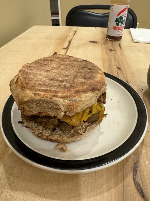 Vegan breakfast sandwich with everything (English muffin with vegan sausage, vegan egg, vegan cheese).  at Common Crumb in Troy