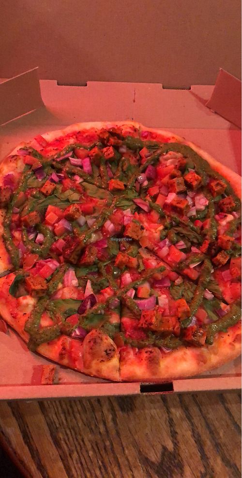 Pizza with tomato sauce, veggies, seitan and vegan pesto at Marquis Pizza in Denver