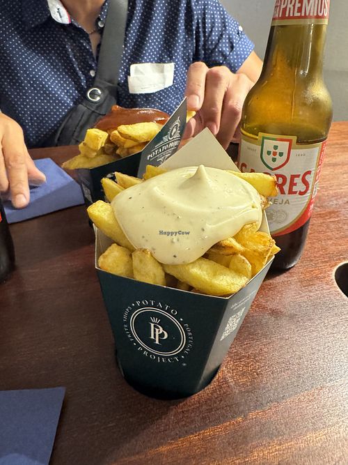 Curry sauce (red, it’s sweet and savoury) and truffle sauce (white in front)  at Potato Project in Lisbon