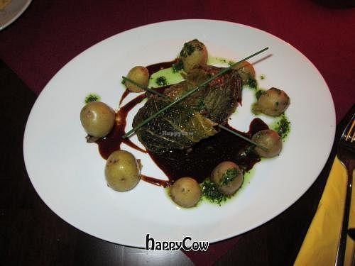 Kohlrabi schnitzel served with a chicory and orange ragout and a green puree at Vaust Braugaststatte in Berlin
