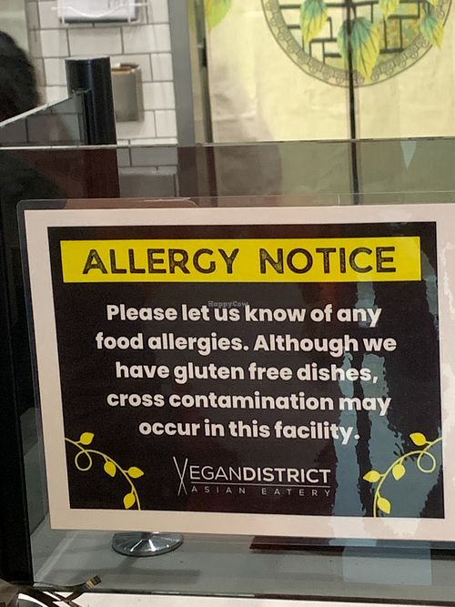 Allgergy sign next to restaurant counter at Vegan District Asian Eatery in Loma Linda