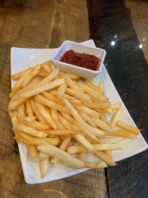 Fries with ketchup at Vegan District Asian Eatery in Loma Linda