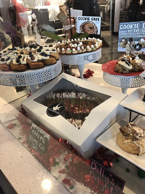 Display with cake-sized options & edible cookie dough by the scoop  at Cinnaholic in Gallatin