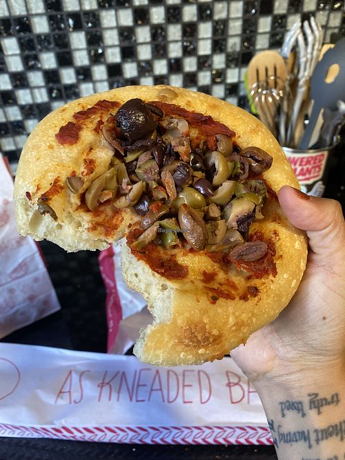 Digging into the Olive (Vegan) Pizzetta 😋  at As Kneaded Bakery in San Leandro