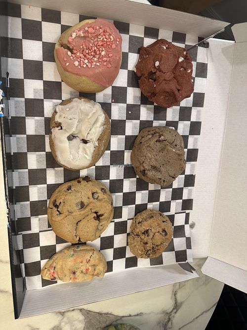Left to right: strawberry, red velvet, cinnamon roll, cookies and cream, chocolate chip, oatmeal raisin, and birthday cake  at MidnighTreats in Arlington