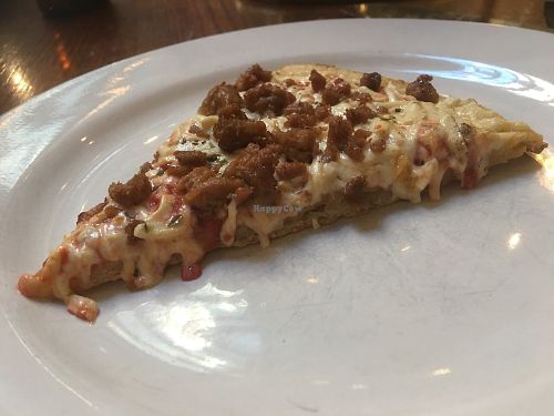 Vegan pizza with cheese and sausage at District of Pi Pizzeria in Washington