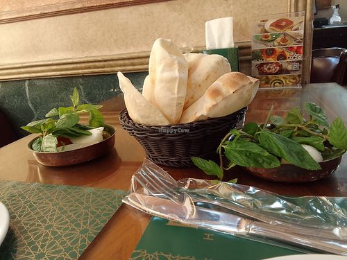 Fresh pita from oven with olives, greens, radishes. at Hallab 1881 قصر الحلو in Tripoli