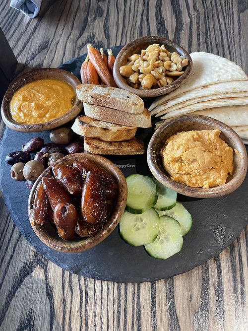 MEZEH 
marinated olives, roasted carrots, hummus, apricot glazed cashews, cucumbers, dates, grilled flatbread  at Carabiner in Big Sky