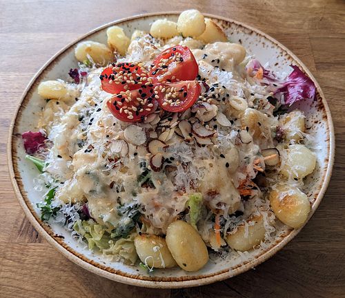 Fried gnocchi with sage and garlic and salad at Deli Kitchen in Munich