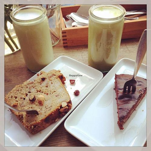 Matcha Latte with coconut rice milk, pear brownie and banana hazelnut cake with crumbles. at Deli Kitchen in Munich