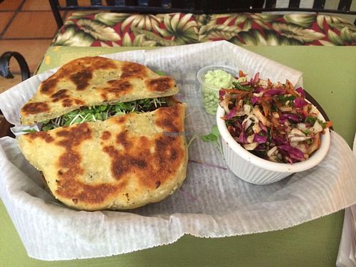 $10 special: chocolate black bean burger on naan bread (naan has dairy), house made slaw, vegan cilantro sauce, and tea at Mother Earth Sanctuary Cafe in Lake Worth