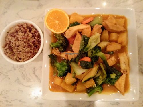 Fried tofu with veggies in a super rich orange sauce, with brown rice on the side. at Araya's Place in Bellevue